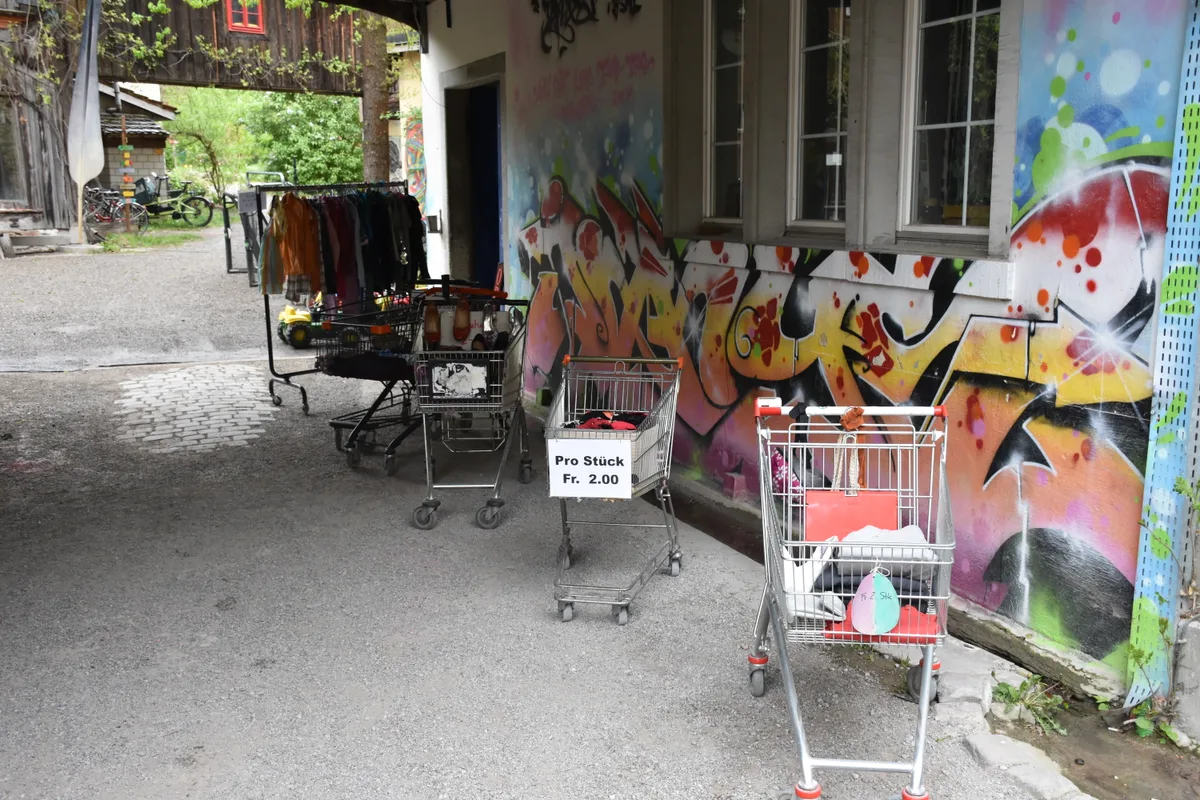 Einkaufswagen mit Kleidern.